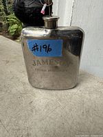 Metal Jameson Irish Whiskey flask with visible small ding on the front side and screw-top closure
