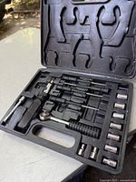 Open black molded plastic case showing Jobmate ratchet wrench, sockets, screwdriver handle, screwdriver and hex bits, and hex keys all neatly set in dedicated slots.