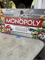 Closed Monopoly Nintendo Collector's Edition box with artwork of Mario, Luigi, Bowser, Princess Peach and other Nintendo characters.