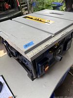 Photo showing the metal work surface with ruler guides, saw blade slot, and overall compact design.