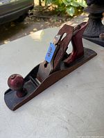Front and side view of vintage #5 hand planer showing wooden front knob, rear handle, and rust on metal base.