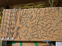 Overview of all pegboard hooks and racks arranged on board