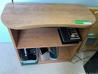 Front view of wooden two-shelf bookcase showing curved top and shelves