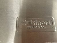 Close-up of embossed Cuisinart Griddler Deluxe logo on stainless housing