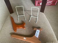 Four assorted decorative plate stands displayed on a chair