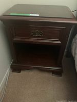 Front view showing drawer, shelf and feet