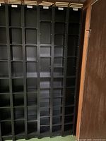 Front view of six black media towers with extra shelves stacked on top