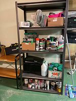 Full view of five-tier metal shelving rack with contents shown for scale