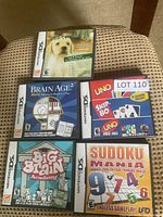All five Nintendo DS game cases on chair