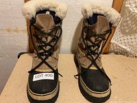 Front view of both Sorel boots showing lacing, cuffs, rubber shells