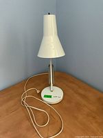 Lamp standing upright, conical shade, round base with cord