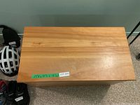 Top view of closed wooden toy chest showing finish and dimension label 17.5 H x 31 W x 16.25 D inches