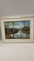 Full view of framed autumn landscape painting with lake and trees by Ginette Brudreault titled Influence Amoureuse.
