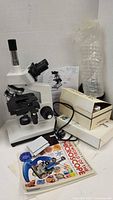 Overview showing microscope, boxes, petri dishes, book