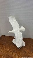 Front view of white porcelain eagle figurine with outstretched wings