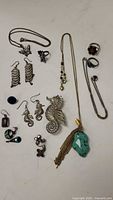 Overview of various Mexican silver jewelry including necklaces, pendants, earrings, and rings.