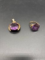 Pendant and ring displayed together on black background