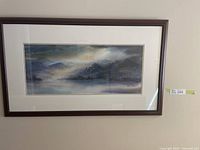 Full view of the framed print showing the foggy mountain scene and the wide matting inside a dark wood frame.