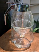 Front angle view showing the glass body with honeycomb pattern and metal handle.