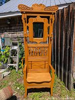 Full front view of the refinished oak hall rack outdoors