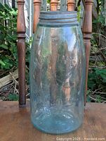 Front view of one antique Mason's 1858 quart glass jar showing embossed text