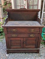 Front view showing overall piece, drawers, cabinet, backsplash