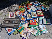 Original Intellivision console and scattered game boxes on ground