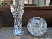 Two vintage American cut glass crystal vases, one tall with scalloped rim, the other spherical, shown from top and side views