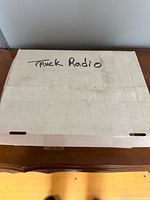 Closed cardboard box labeled Truck Radio