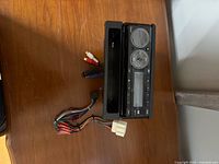 Front view of Dual XRM410 head unit with faceplate and wiring harness