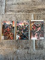 Three bagged DC comic books laid out side by side