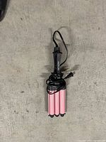 Top view of Revlon triple-barrel curling iron with cord wrapped