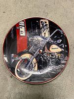 Front of plate showing motorcycle artwork and red rim