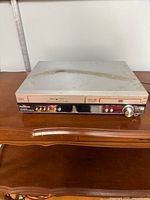 Front view of Panasonic SA-HT810V DVD/VCR combo showing overall condition and dust on top