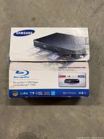 Retail box displaying Samsung BD-F5100 Blu-ray Disc/DVD Player branding