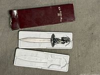 Dragon-handled letter opener in foam insert with maroon Tudor Mint box