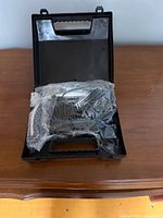 Open case showing Conair clipper and guards sealed in plastic