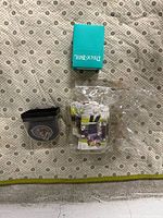 Top view showing hockey puck, teal Deck Box and stack of trading cards