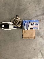 Full-size iron with cord, travel iron in box