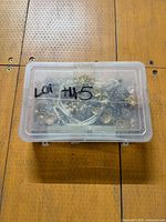 Closed clear plastic case holding jewelry