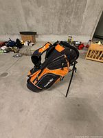 PowerBilt orange and black junior stand golf bag upright