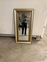 Front view of rectangular mirror with gold frame