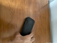 Monocular in hand showing size and rubberized exterior