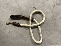 Off-white rope leash with leather accents and brass clip