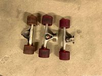 Three skateboard truck assemblies each with two wheels