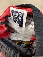 Top view into red backpack showing emergency purified drinking water pouch