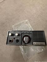 Front view showing model number, controls, microphone jack and speaker grille