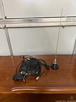 Radio body, microphone, cables and antenna displayed on table