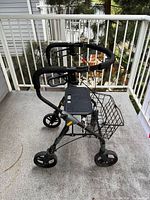 Side view of rollator walker showing wheels, basket, seat, and handles