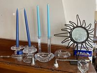 Photo showing all 8 assorted candle related items on a wooden surface